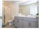 Modern bathroom with gray vanity and walk-in shower at 1692 Tropical Palms Cir, Kissimmee, FL 34747
