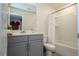 Bathroom with tub, vanity, and gray cabinets at 1692 Tropical Palms Cir, Kissimmee, FL 34747