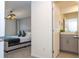 View of bedroom and ensuite bathroom with gray vanity at 1692 Tropical Palms Cir, Kissimmee, FL 34747