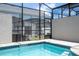 Inviting screened pool with tiled deck at 1692 Tropical Palms Cir, Kissimmee, FL 34747