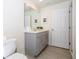 Clean bathroom with gray vanity and a large mirror at 1692 Tropical Palms Cir, Kissimmee, FL 34747