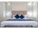 Main bedroom with tufted headboard, stylish lamps, and a cozy bench at 1692 Tropical Palms Cir, Kissimmee, FL 34747