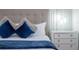 Main bedroom features a plush bed with blue pillows and white bedding at 1692 Tropical Palms Cir, Kissimmee, FL 34747
