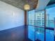 Spacious living area with large windows and a chic chandelier at 155 S Court Ave # 1610, Orlando, FL 32801