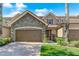 Two story home with stone accents and brown double doors garage at 10747 Belfry Cir, Orlando, FL 32832