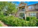 Townhouse exterior with patio and landscaped yard at 10747 Belfry Cir, Orlando, FL 32832