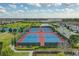 Community tennis courts with surrounding green space and residential homes at 10747 Belfry Cir, Orlando, FL 32832