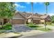 Townhouses with stone accents and brown double doors garage at 10747 Belfry Cir, Orlando, FL 32832