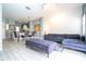 Open-concept living room, kitchen, and dining area with gray sectional at 3004 White Orchid Rd, Kissimmee, FL 34747