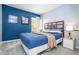 Blue walls and a comfortable bed in this bedroom at 3004 White Orchid Rd, Kissimmee, FL 34747