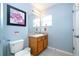 Bathroom with wood vanity and large mirror at 3004 White Orchid Rd, Kissimmee, FL 34747