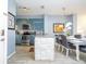 Modern kitchen with teal cabinets, stainless steel appliances, and granite countertops at 3004 White Orchid Rd, Kissimmee, FL 34747