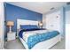 King bedroom with white bed frame and blue walls at 3004 White Orchid Rd, Kissimmee, FL 34747