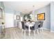 Bright dining room with white table and gray chairs, adjacent to kitchen at 3004 White Orchid Rd, Kissimmee, FL 34747