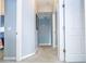 Hallway with carpet, light blue walls and doors to bedrooms at 3004 White Orchid Rd, Kissimmee, FL 34747