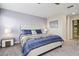 Primary bedroom with king-size bed and ensuite bathroom at 1585 Mulligan Blvd, Davenport, FL 33896