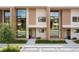 Modern townhouses with large windows and a neutral color palette at 7487 Brooklyn Dr, Kissimmee, FL 34747