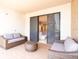 Outdoor patio with wicker furniture and sliding glass doors leading inside at 7487 Brooklyn Dr, Kissimmee, FL 34747
