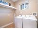 Laundry room with washer, dryer, and shelving at 7487 Brooklyn Dr, Kissimmee, FL 34747