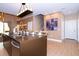 Modern kitchen island with seating and a view of the living area at 7487 Brooklyn Dr, Kissimmee, FL 34747
