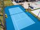 Blue tennis court with yellow accents at 7487 Brooklyn Dr, Kissimmee, FL 34747