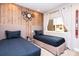 Two twin beds in a bedroom featuring wood-paneled accent wall at 7487 Brooklyn Dr, Kissimmee, FL 34747