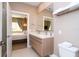 Clean bathroom with a double vanity and a view into the bedroom at 7487 Brooklyn Dr, Kissimmee, FL 34747