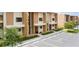 Modern building exterior with parking and landscaping at 7487 Brooklyn Dr, Kissimmee, FL 34747