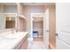 Modern bathroom with double vanity and a walk-in closet at 7487 Brooklyn Dr, Kissimmee, FL 34747