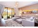 Bright living room with sectional sofa and access to backyard patio at 7487 Brooklyn Dr, Kissimmee, FL 34747