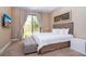 Cozy bedroom with a queen-size bed and private patio access at 7487 Brooklyn Dr, Kissimmee, FL 34747
