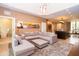 Open concept living room with a sectional sofa and a modern kitchen at 7487 Brooklyn Dr, Kissimmee, FL 34747