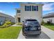 Two-story house with a dark-colored SUV parked in the driveway at 1839 Wild Rye Way, Kissimmee, FL 34744