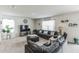 Living room with sectional sofa and a large TV at 1839 Wild Rye Way, Kissimmee, FL 34744