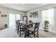 Bright dining room with table and chairs, and sliding glass doors leading to backyard at 1839 Wild Rye Way, Kissimmee, FL 34744
