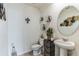Small powder room with pedestal sink and toilet at 1839 Wild Rye Way, Kissimmee, FL 34744