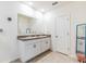 Double vanity bathroom with granite countertops and white cabinets at 1839 Wild Rye Way, Kissimmee, FL 34744