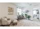 Bright sitting area with chair, ottoman, and several plants at 1839 Wild Rye Way, Kissimmee, FL 34744