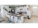 Modern kitchen with white cabinets and a large island at 1839 Wild Rye Way, Kissimmee, FL 34744