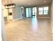 Open living room with tile floors and modern lighting at 2310 Hamilton Ridge Rd, Clermont, FL 34715