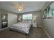 King-size bed, ceiling fan, and double doors at 2937 Banana Palm Dr, Kissimmee, FL 34747