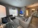 Spacious living room featuring a sectional sofa, armchairs, and large TV at 2937 Banana Palm Dr, Kissimmee, FL 34747
