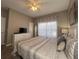 King-size bed, ceiling fan, and large windows at 2937 Banana Palm Dr, Kissimmee, FL 34747