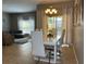 Dining room with modern white table, chairs, and a chandelier at 2937 Banana Palm Dr, Kissimmee, FL 34747