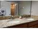 Double vanity bathroom with granite countertop and large mirror at 2937 Banana Palm Dr, Kissimmee, FL 34747