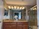 Double vanity, granite countertop, and shower at 2937 Banana Palm Dr, Kissimmee, FL 34747