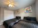 Bedroom with two twin beds, ceiling fan, and modern art at 2937 Banana Palm Dr, Kissimmee, FL 34747