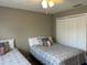 Bedroom with two twin beds, ceiling fan, and window at 2937 Banana Palm Dr, Kissimmee, FL 34747