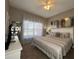 King-size bed, ceiling fan, and large windows at 2937 Banana Palm Dr, Kissimmee, FL 34747