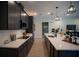 Modern kitchen featuring dark cabinetry, quartz countertops, and stainless steel appliances at 1629 Andover Ridge Dr, Deland, FL 32720